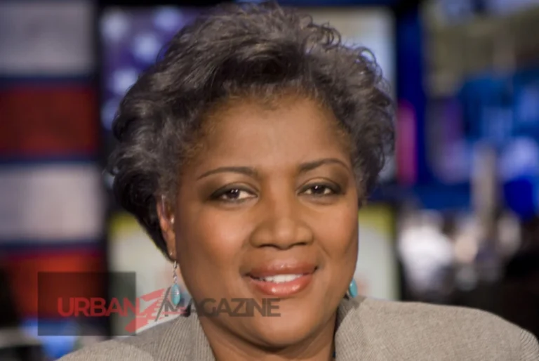 Donna Brazile smiling, wearing a professional suit, with a backdrop of political campaign posters and financial graphs illustrating her net worth growth.